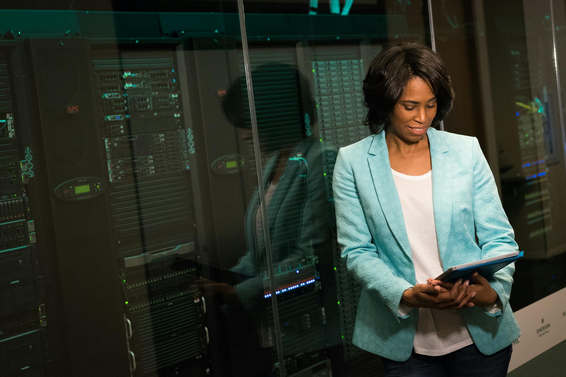 IT professional examining cloud hosting servers in a modern data center