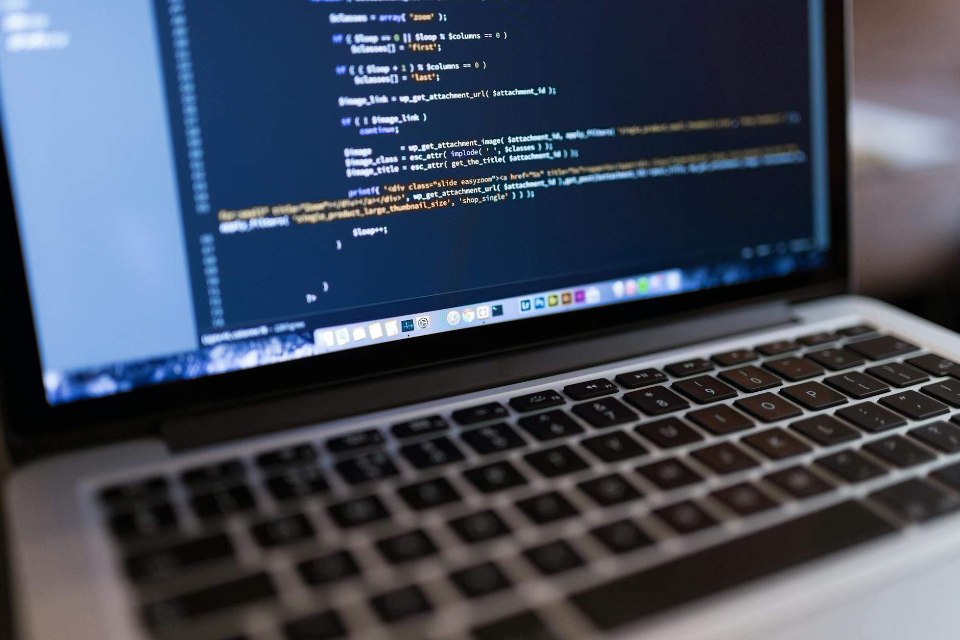 Code on laptop screen for WordPress website optimization and hosting setup