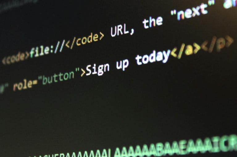 How to Back Up Your Website: Complete Guide (2026) - Detailed view of HTML and CSS code on a computer screen, concept of prog