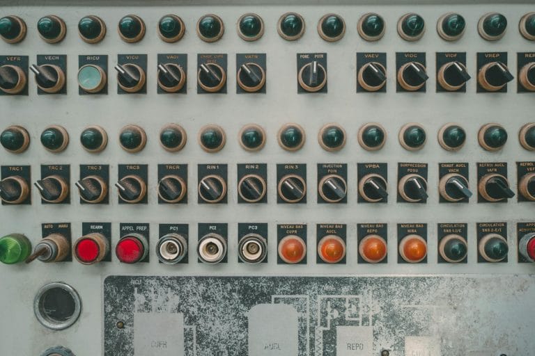 What Is cPanel Hosting? A Beginner's Complete Guide (2026) - Close-up of a vintage industrial control panel with multiple but